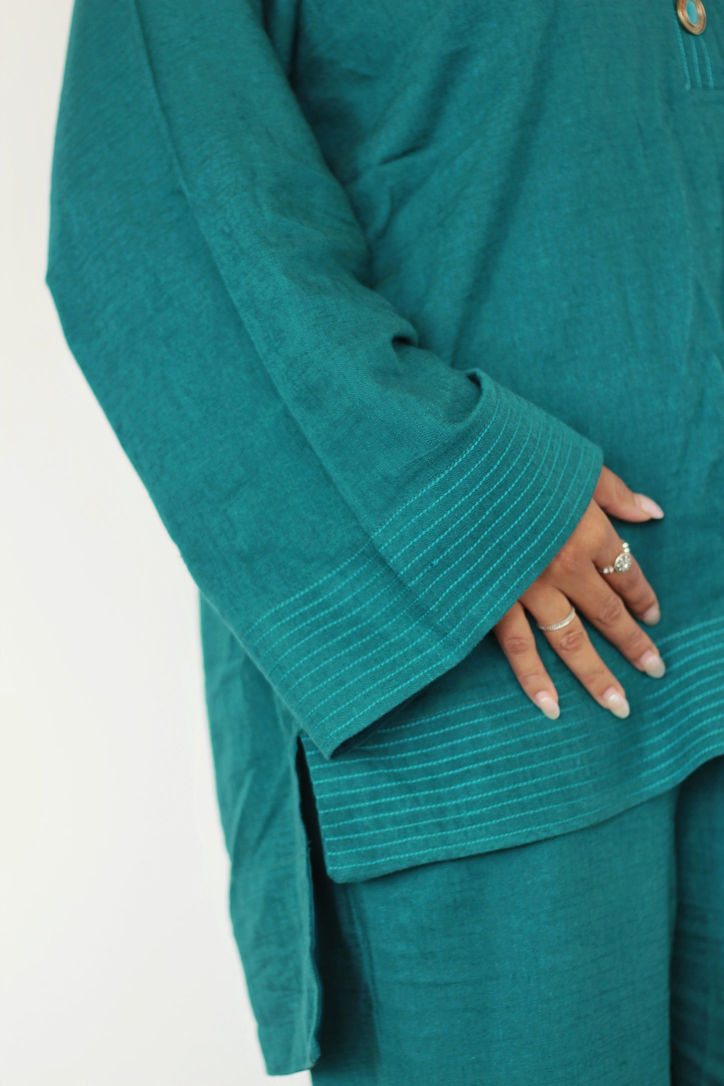 Teal linen top Pakistani Suit with turquoise gem buttons, close-up of sleeves. Warm and comfortable, perfect for fall and winter.